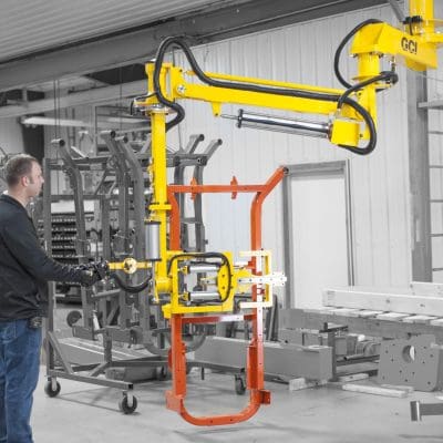 An operator easily moves a steel frame utilizing an overhead mount manipulator.