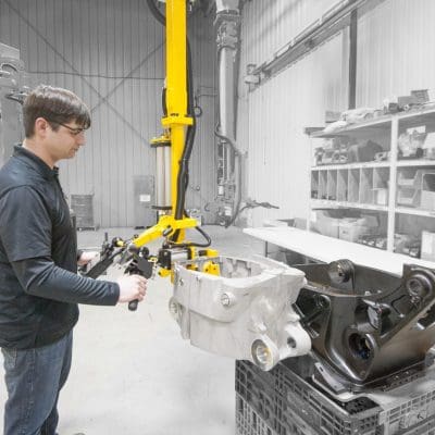 Operator lifts 60 lb engine casting with a GCI manipulator.