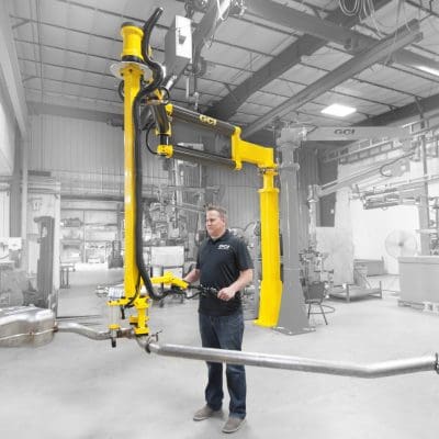 Operator lifts heavy exhaust with a GCI industrial manipulator